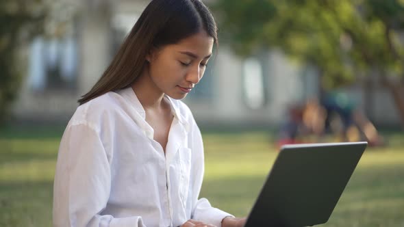 Portrait of Young Asian Female Student Outdoors