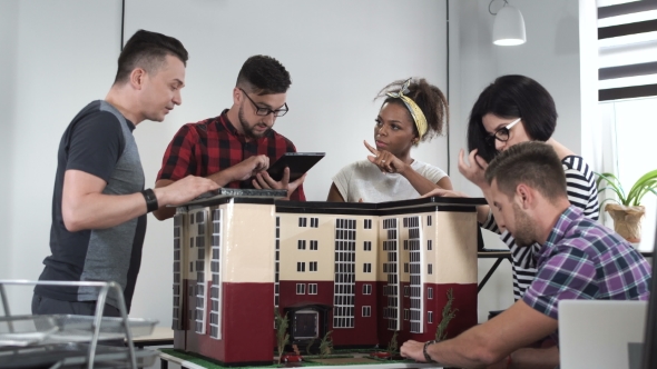 Designers Working with Mockup of House