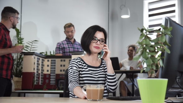 Young Woman Talking Phone in Office