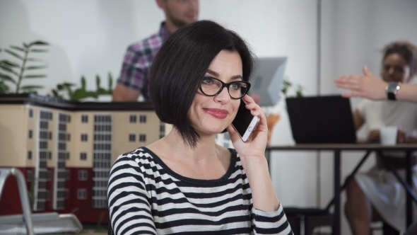 Young Woman Talking Phone in Office