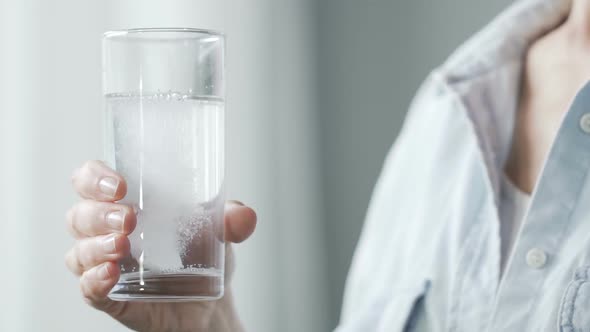 Lady Putting Aspirin Tablet Into Glass of Water, Drinking Painkiller Medicine