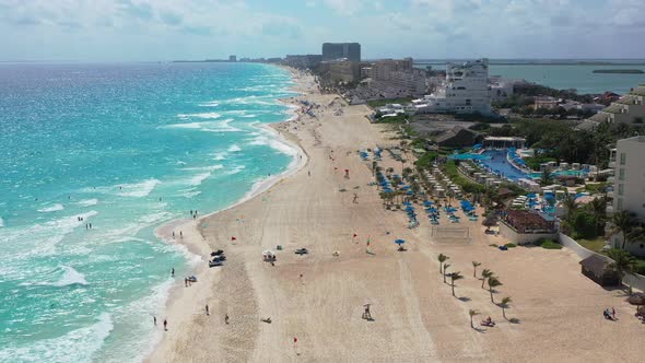 Camera approaches Cancun's sandy beach and turquoise water