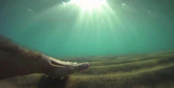 Slow Motion Hand In Underwater Sand