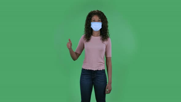 Portrait of Beautiful African American Young Woman in Medical Protective Face Mask Looking at Camera