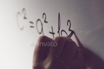 theorem, math class in the school with teacher writing mathematical formula on white board, selective focus