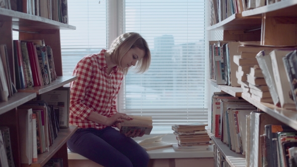 Thoughtful Young Lady Looking Through Books