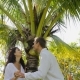 Couple Stand Under Palm Tree Kiss Talking In Tropical Garden , Happy Man And Woman Outdoors - VideoHive Item for Sale