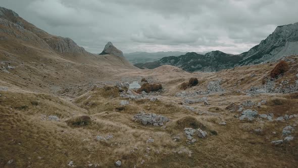 Flying above the autumn mountains of Durmitor in Montenegro. Aerial view of National park in fall