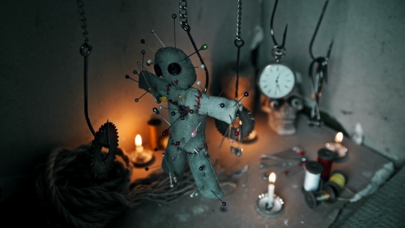 the Magician Removes the Voodoo Doll Off the Hook