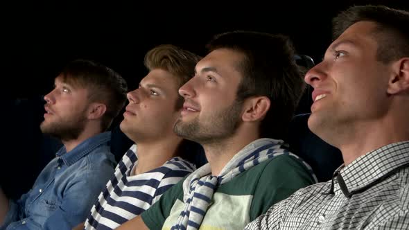 Young People Watching Movie in Cinema. Eating Popcorn and Laughing. Close Up