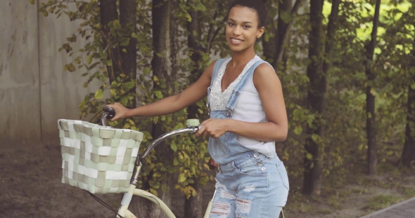 Woman Posing with Bicycle at Street