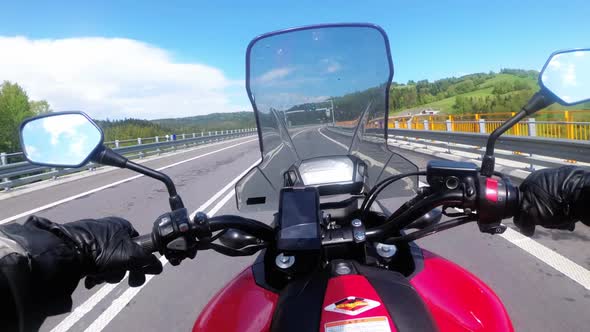 Motorcyclist Riding on Empty Highway. View From Behind the Wheel of a Motorbike. POV