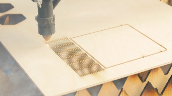 Laser Torch Cuts a Wooden Board or Plywood