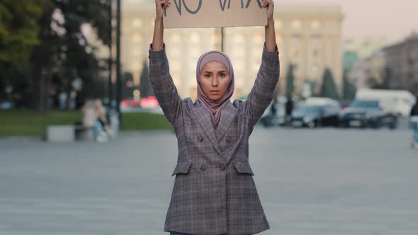 Young Serious Muslim Woman Islamic Girl in Hijab Female Activist Stands in City Street Protesting