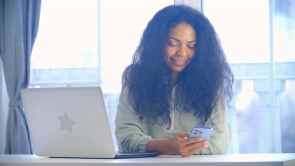 Happy freelancer woman browsing internet on smart phone in close up video