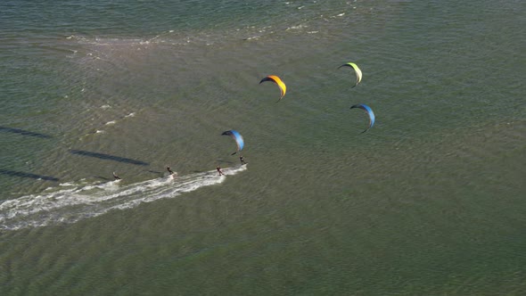 People kitesurfing on windy day on Netherlands coastline, aerial view