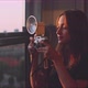 Woman photographer taking a picture from the balcony close up - VideoHive Item for Sale