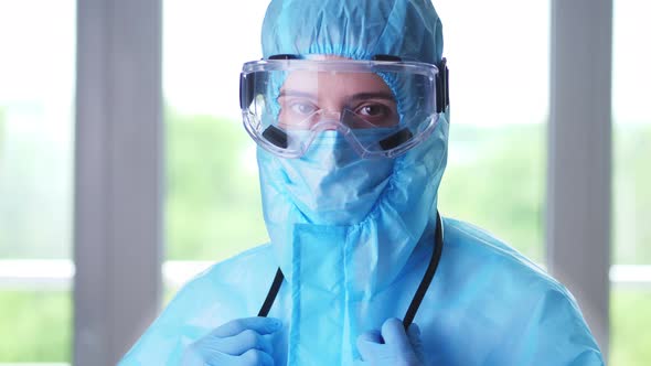 Portrait of Female Medical Worker, Doctor or Nurse, in Special Protective Uniform, Mask, Glasses alt