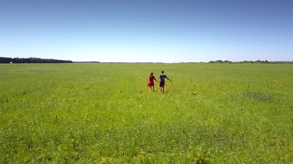 Green Sparkling Grass Moves and Surrounds Pretty Couple