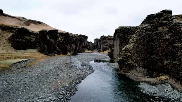 Drone flying up river Fjaðrárgljúfur Canyon in Iceland