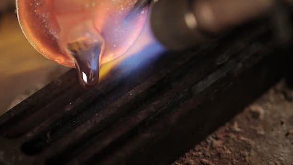 Pouring molten silver into a mold