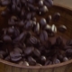 The Coffee Beans Fall on the Table in a Wooden Dish. The Gray Background. The Fall and Flight of - VideoHive Item for Sale