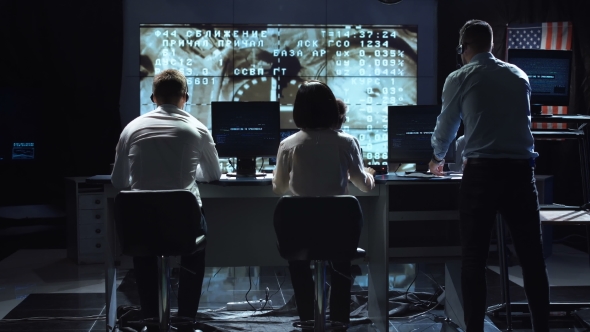 People Working in Mission Control Center. Elements of This Image Furnished By NASA.