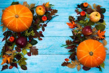 tumn leaves on blue wooden table. Fall background with seasonal vegetables and fruits, copy space