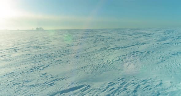 Aerial View of Cold Winter Landscape Arctic Field Trees Covered with Frost Snow Ice River and Sun