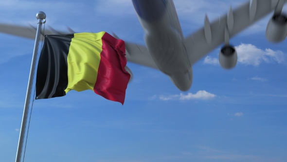 Commercial Airplane Landing Behind Waving Belgian Flag