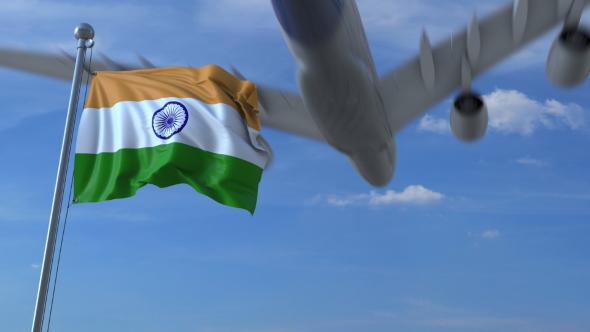 Commercial Airplane Landing Behind Waving Indian Flag