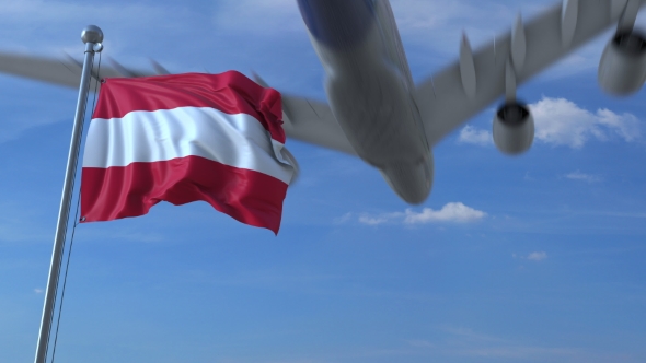 Commercial Airplane Landing Behind Waving Austrian Flag