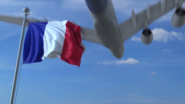 Commercial Airplane Landing Behind Waving French Flag