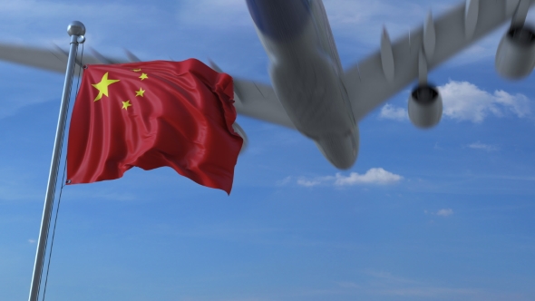 Commercial Airplane Landing Behind Waving Chinese Flag