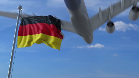 Commercial Airplane Landing Behind Waving German Flag alt