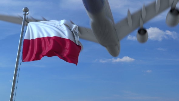 Commercial Airplane Landing Behind Waving Polish Flag