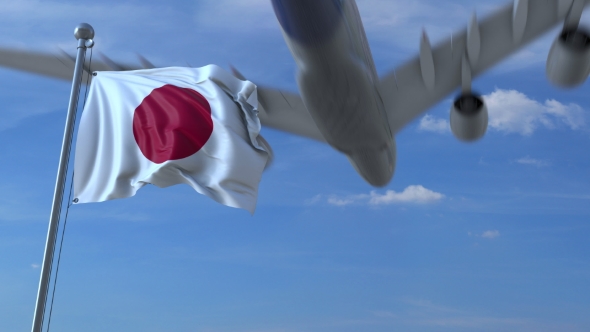 Commercial Airplane Landing Behind Waving Japanese Flag