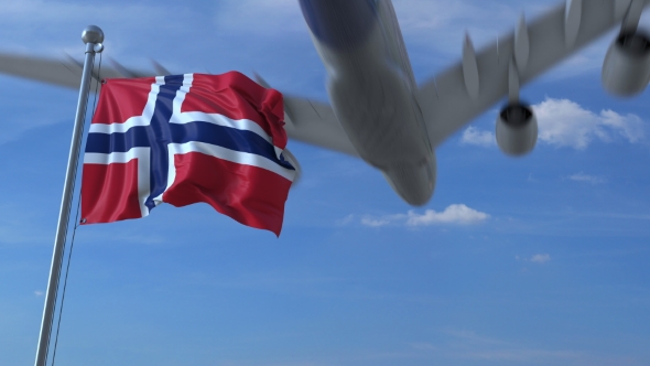 Commercial Airplane Landing Behind Waving Norwegian Flag