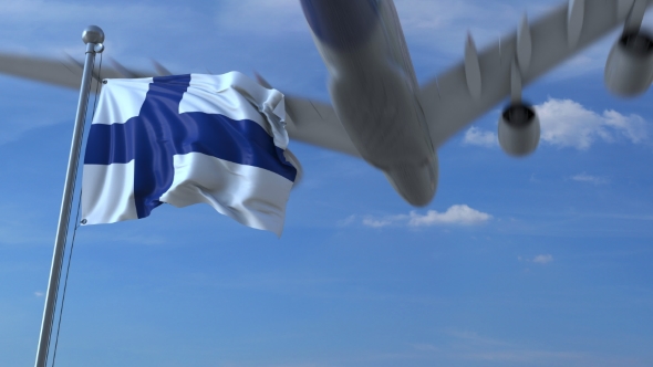 Commercial Airplane Landing Behind Waving Finnish Flag alt
