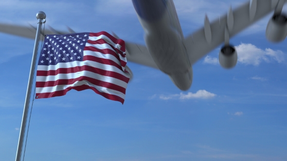 Commercial Airplane Landing Behind Waving American Flag alt