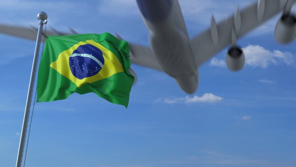 Commercial Airplane Landing Behind Waving Brazilian Flag