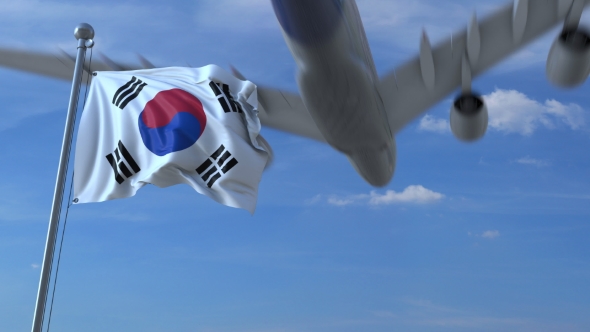 Commercial Airplane Landing Behind Waving Korean Flag