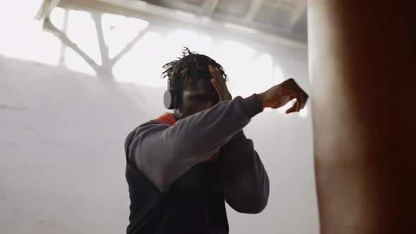 Low Angle Footage Young Male Boxer Practicing Shadow Boxing in Headphones