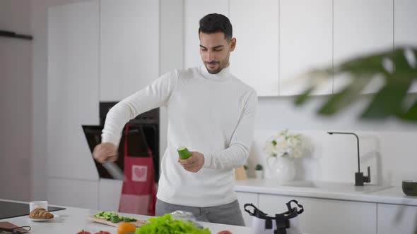 Cheerful Confident Chef Juggling Knife and Cutting Cucumber Looking at Camera Laughing