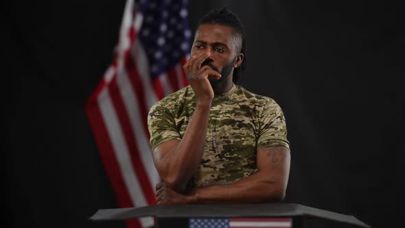 Portrait of Serious Male African American Soldier Clarifying Question From Audience Standing at