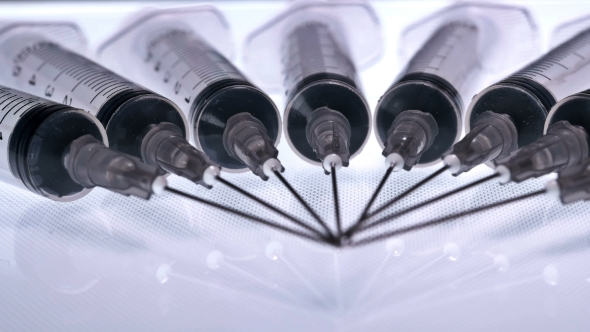 A Lot of Syringes with Liquid on a White Background