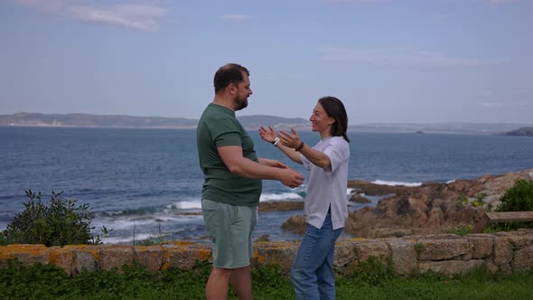 Happy Meeting of a Guy and a Girl Near the Ocean