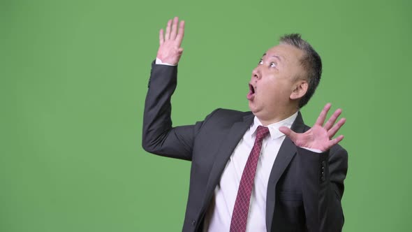 Mature Japanese Businessman Shocked and Surprised While Looking Up