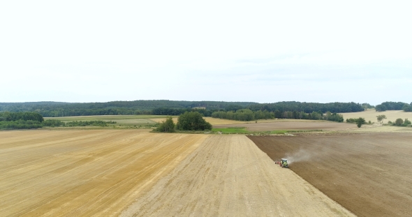 Agricultural Tractor Sowing and Cultivating Agricultural Field.