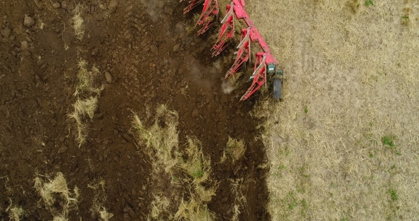 Agricultural Tractor Plowing Field